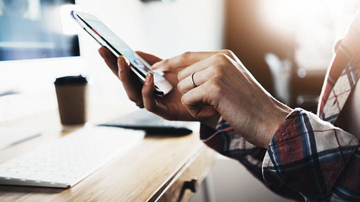 Hand using smartphone for Trelleborg subscriptions