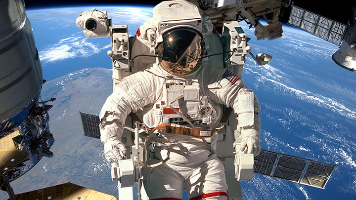 Astronaut in space suit outside International Space Station