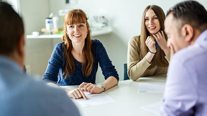 Employees collaborating in a meeting